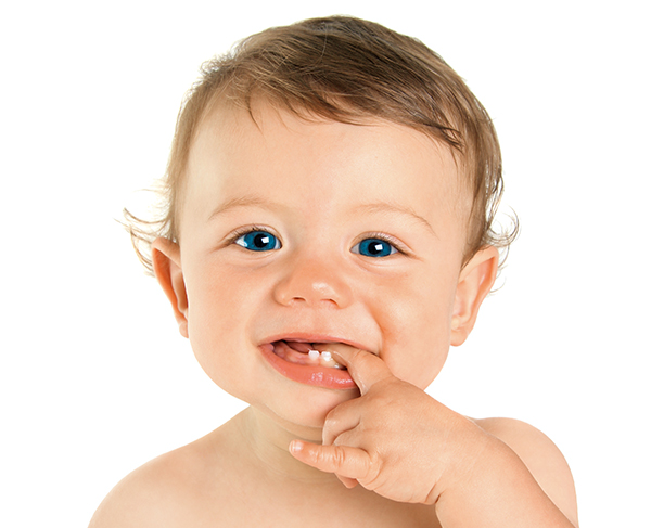 Baby with fingers in mouth, teething